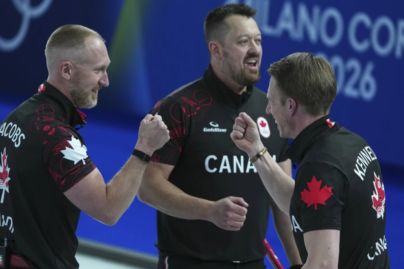Canada’s Marc Kennedy, Brad Jacobs and Ben Hebert react after the men’s curling round robin session against Sweden, at the 2026 Winter Olympics, in Cortina d’Ampezzo, Italy, Friday, Feb. 13, 2026.