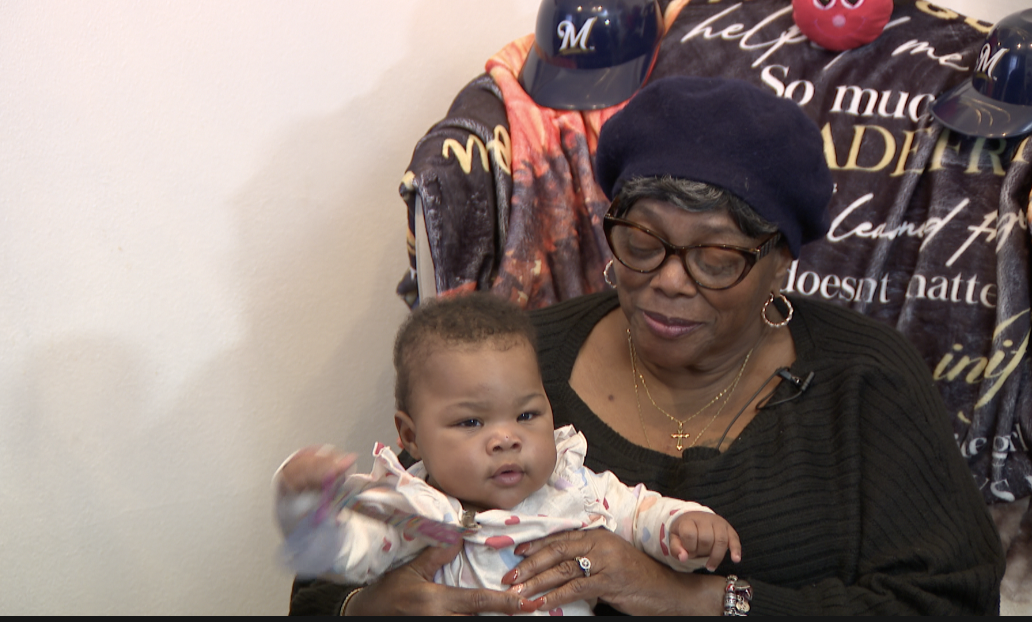 Gloria with one of her great-great grandchildren.png