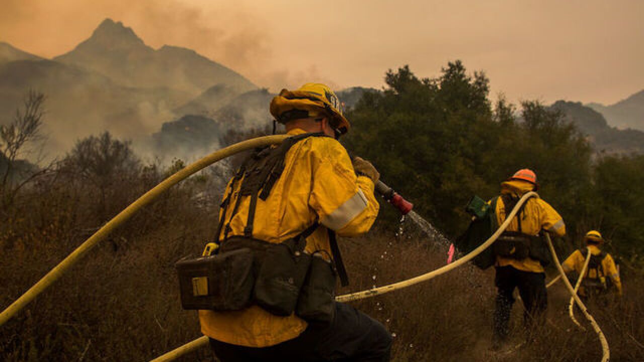 'It's not over yet.' High winds threaten progress made fighting California fires