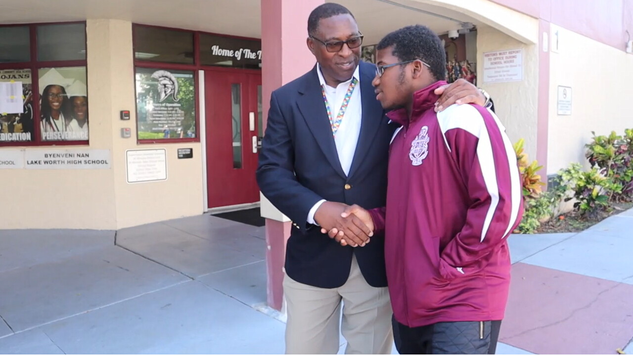 Principal Dr. Elvis Epps from Lake Worth Community High School shakes hands with student Gabriel Henry on May 26, 2022.jpg
