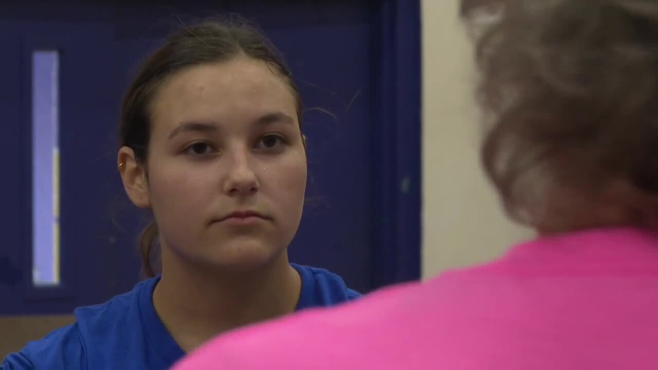 Sarah Montero listens to Lake Worth Christian School volleyball coach Terri Kaiser