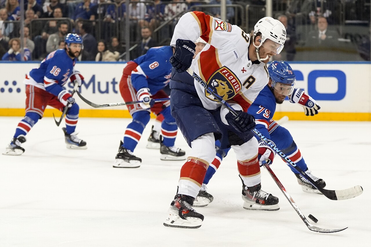 Florida Panthers left wing Matthew Tkachuk and New York Rangers defenseman K'Andre Miller vie for control of puck during first period of Eastern Conference Final, May 22, 2024