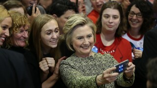 Hillary Clinton taking a selfie on her phone.