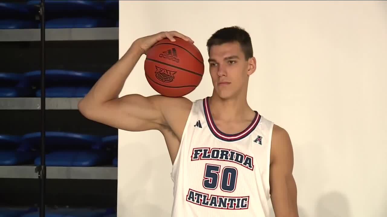 FAU Owls center Vlad Goldin poses with basketball during media day, Oct. 18, 2023