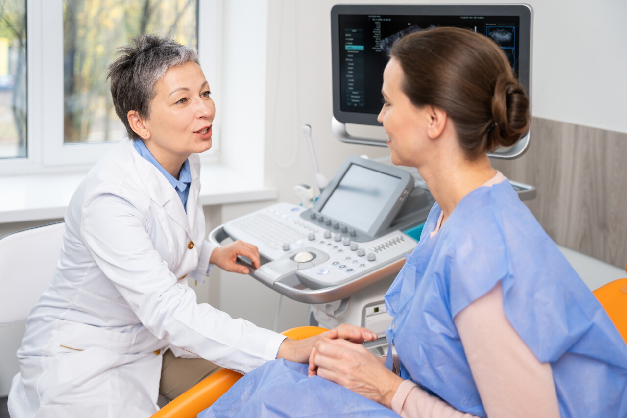 A,Doctor,And,Patient,Converse,During,An,Ultrasound,Appointment,,With