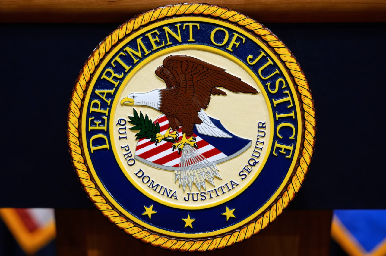 The U.S. Department of Justice logo is seen on a podium before a news conference at the Justice Department in Washington, on May 6, 2025.