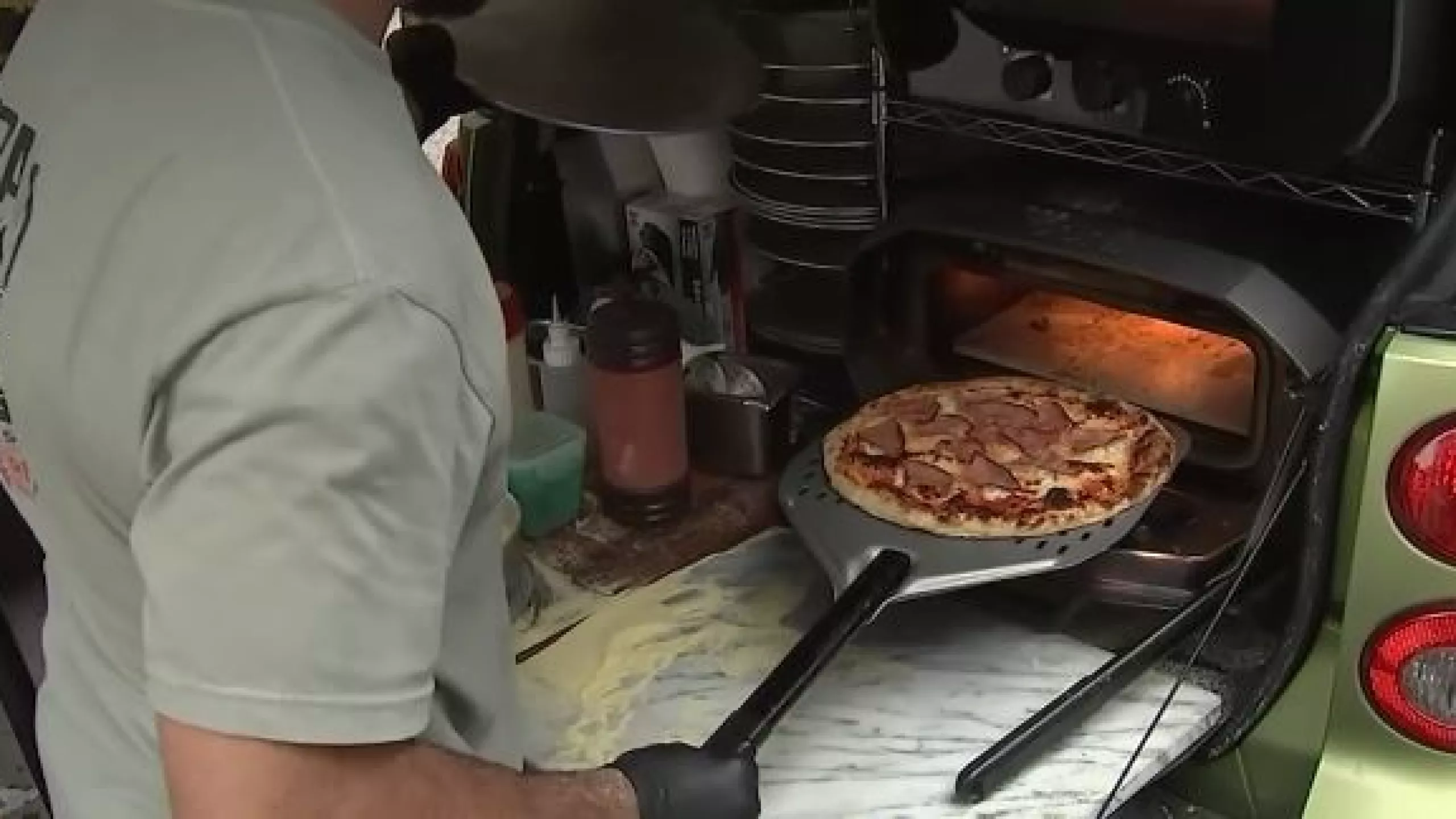 A small Smart car parked at 54th Street and 10th Avenue is turning heads - and stopping pedestrians in their tracks - thanks to the unmistakable aroma of fresh, stone-fired pizza coming from its open trunk.