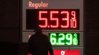 A person walks past a sign for fuel prices at a gas station on Wednesday, May 6, 2026, in Portland, Ore. (AP Photo/Jenny Kane)