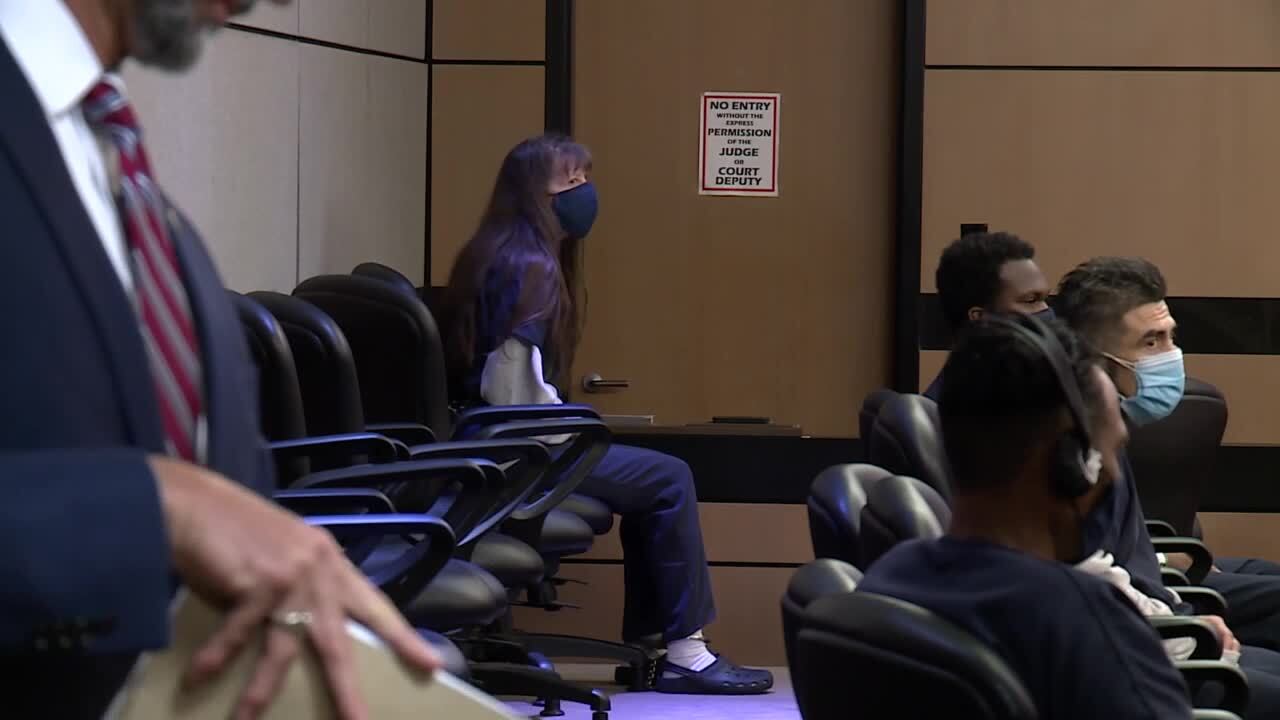 Sheila Keen-Warren sits in shackles in court while prosecutor Reid Scott puts files away, June 14, 2022