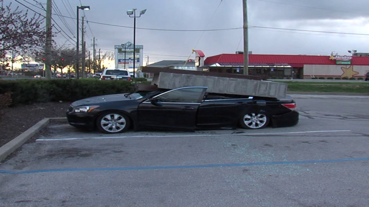 PICS: Sign falls on car, driver gets out