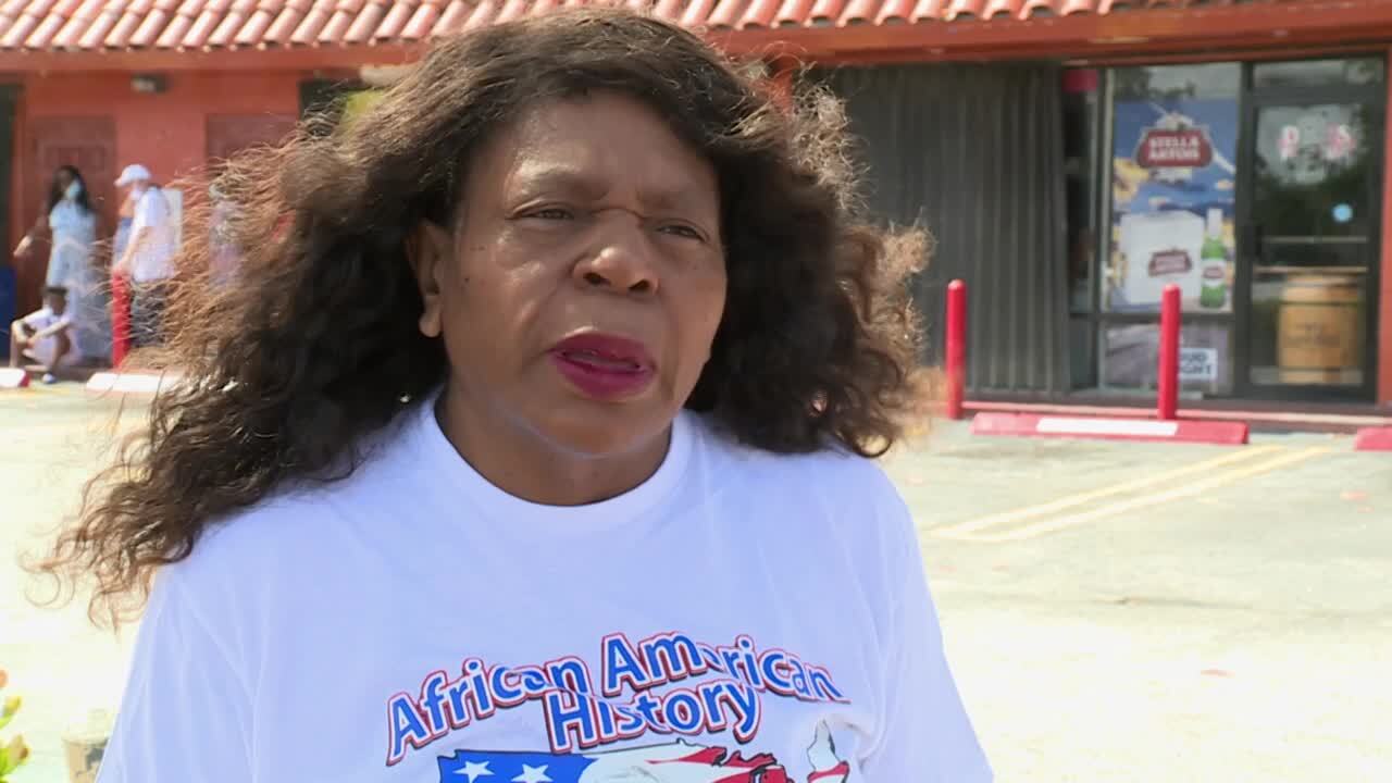 Angela Williams, president and founder of Mothers Against Murderers Association, speaks to WPTV outside Tina's Market