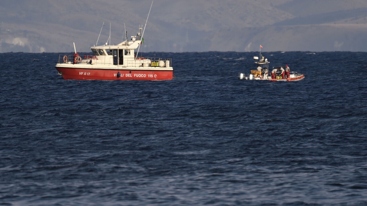 Emergency services at the scene of the search for a missing boat, in Porticello, southern Italy