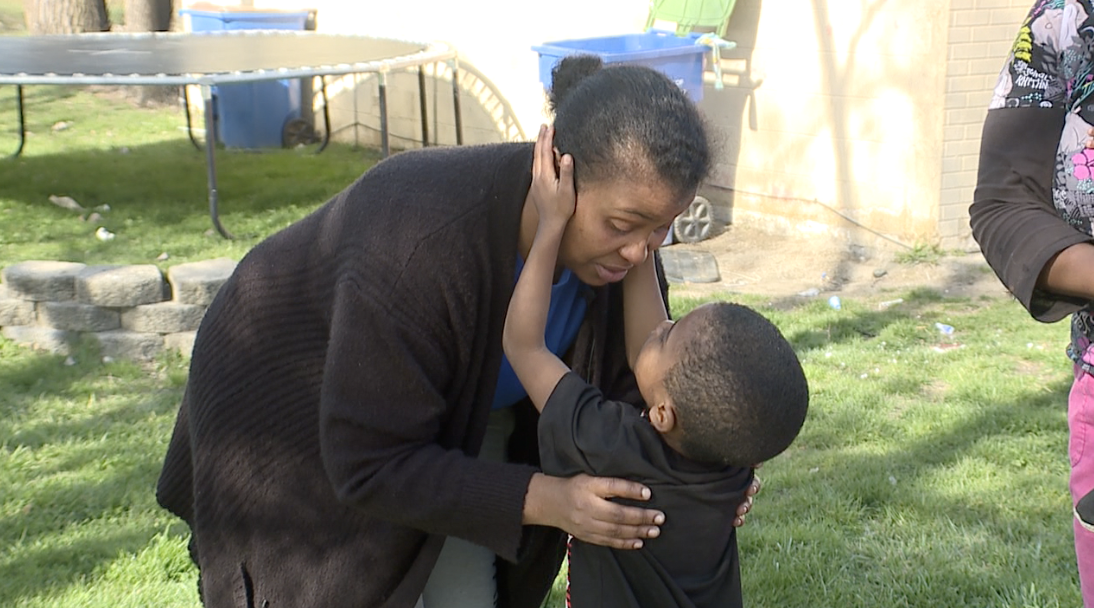 Britteny Lee embracing her 5-year-old son, Juwan Perry Jr. after he saved her life