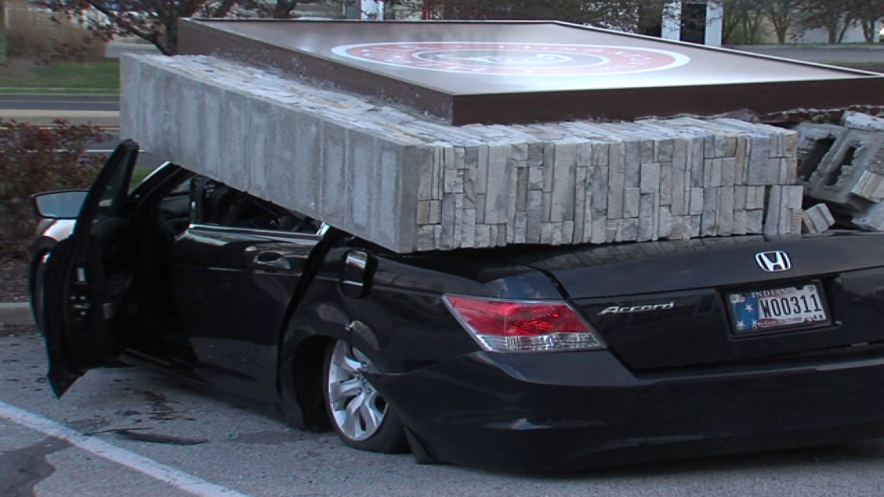 PICS: Sign falls on car, driver gets out