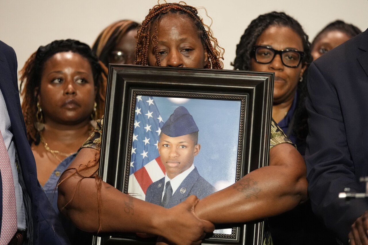 A photo of slain airman Roger Fortson is held by his mother.