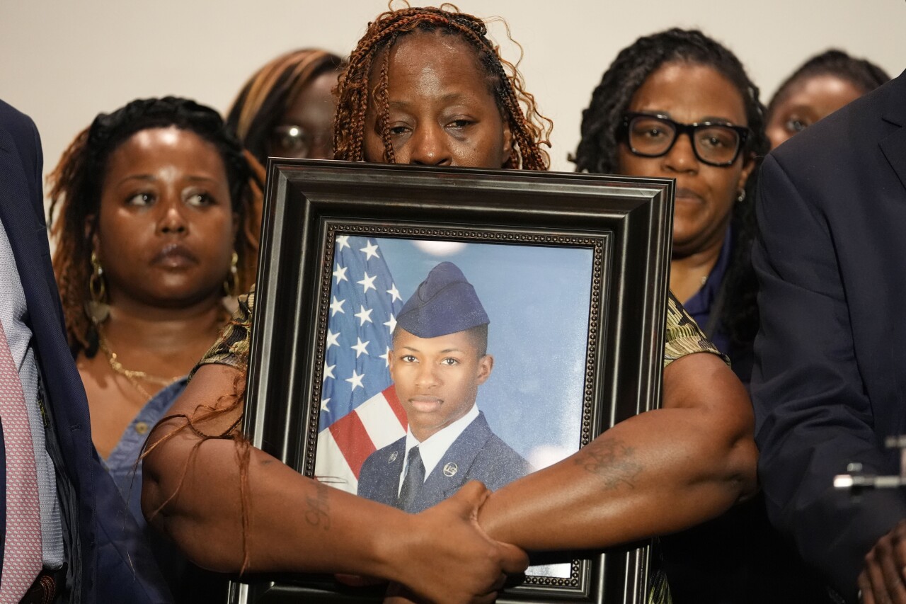 A photo of slain airman Roger Fortson is held by his mother. 