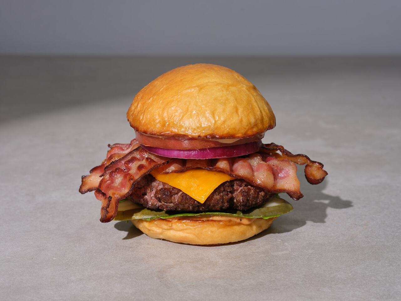 Photo features "Angie's USDA Prime Steakhouse Burger with Bacon and Hand Sliced Sharp Cheddar Cheese.'