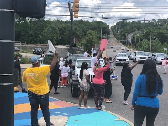 Family and friends gather at an intersection where Nakia Crawford was shot and killed.