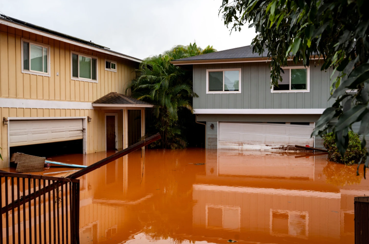 Floodwaters fill the ground level of homes in Waialua, Hawaii, Friday, March 20, 2026.