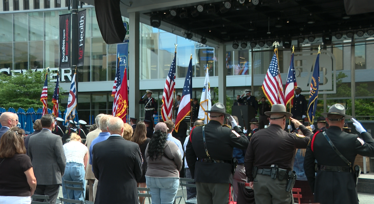 Law enforcement standing at attention during the National Anthem