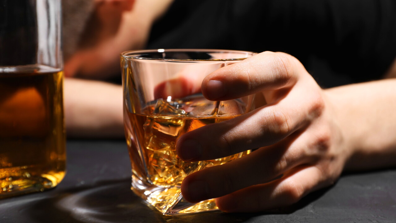 Alcohol,Addiction.,Man,With,Glass,Of,Whiskey,At,Dark,Textured