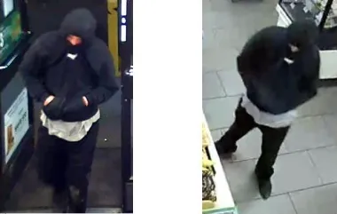 The suspect is described as a white male, last seen wearing a black-hooded sweatshirt with a white design on the front, black pants, black shoes, and a grey shirt underneath the hoodie.