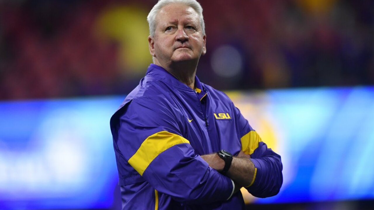 LSU Offensive Coordinator Steve Ensminger watches teams warm up before the first half of the Peach Bowl NCAA semifinal college football playoff game between LSU and Oklahoma, Saturday, Dec. 28, 2019, in Atlanta. Ensminger's daughter-in-law, Carley McCord, died in a plane crash Saturday in Louisiana on the way to the game. (AP Photo/John Amis)