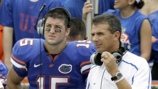 Tim Tebow and Urban Meyer with Florida Gators on sideline in 2009