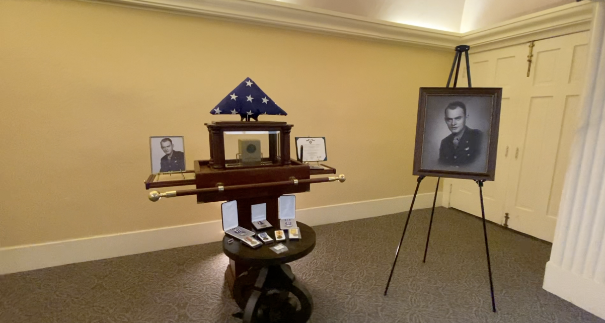 Pictures, flag, and urn with Lt. Parker's remains