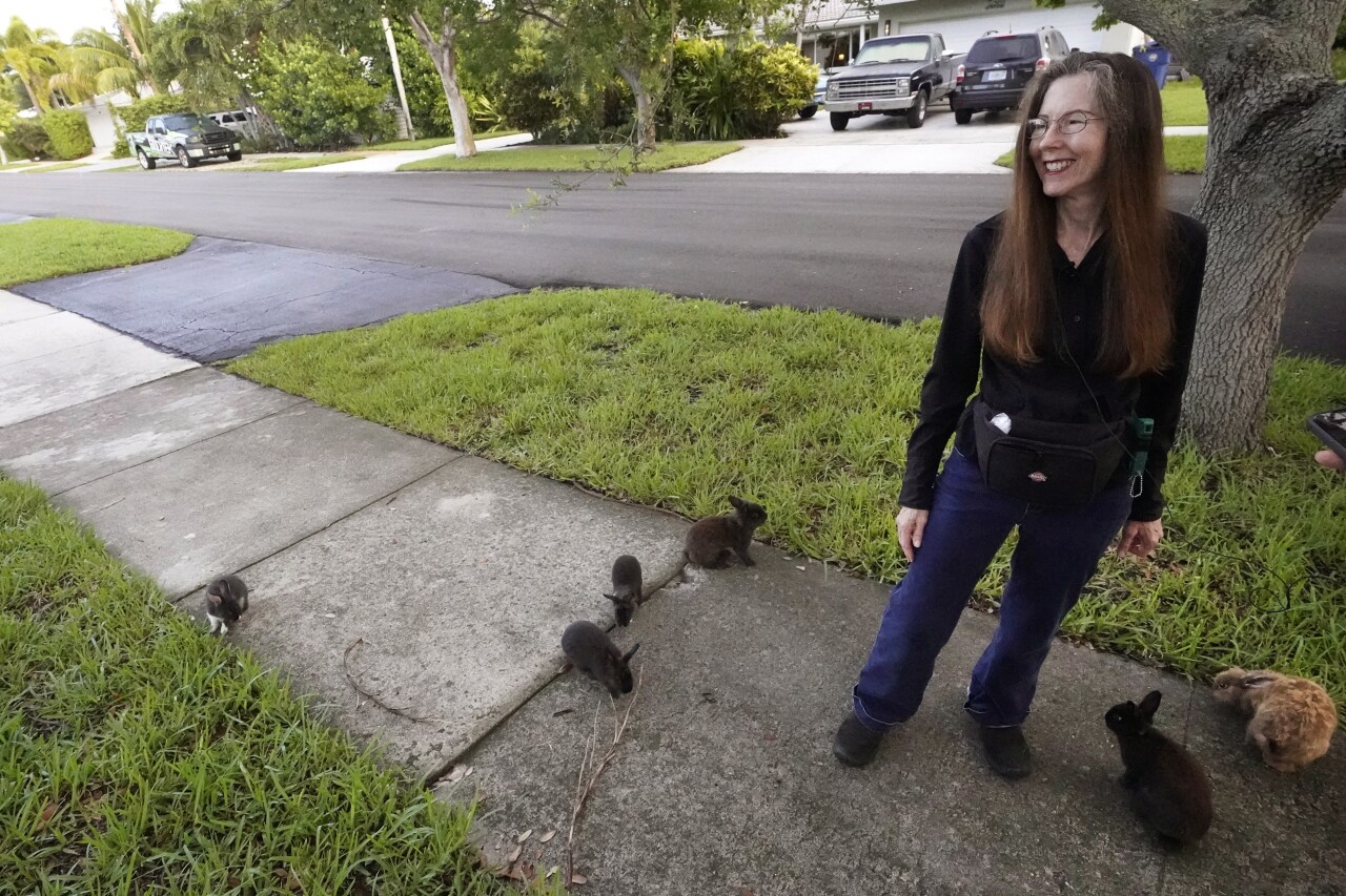 Alicia Griggs with rabbits outside her Wilton Manors home, July 11, 2023
