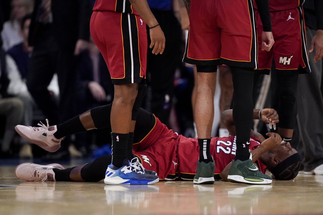 Miami Heat forward Jimmy Butler lies on court after injury in second half of Game 1 of Eastern Conference semifinals playoff series at New York Knicks, April 30, 2023