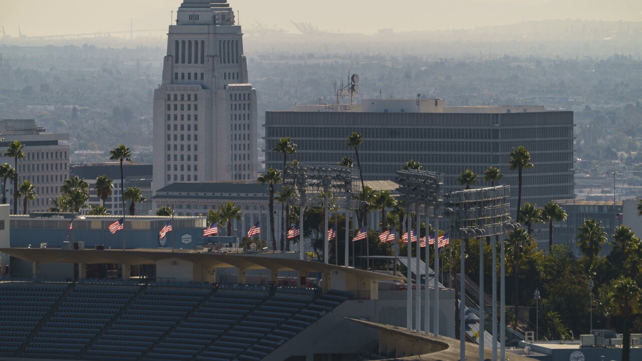 California is transforming baseball stadiums and fairgrounds into mass vaccination sites as the coronavirus surge overwhelms hospitals and sets a deadly new record in the state.