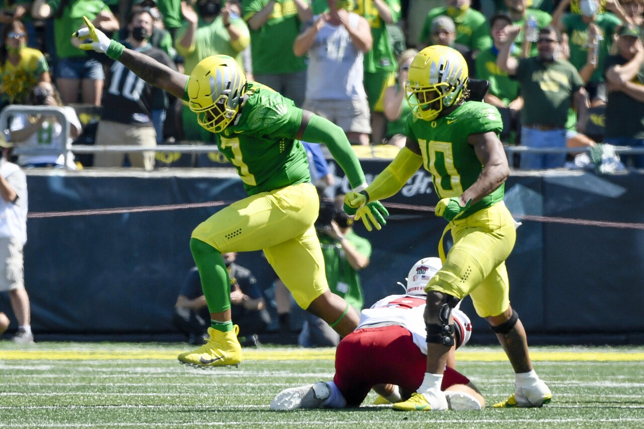 Oregon Ducks defensive tackle Brandon Dorlus and linebacker Justin Flowe celebrate after sacking Fresno State quarterback Jake Haener, Sept. 4, 2021