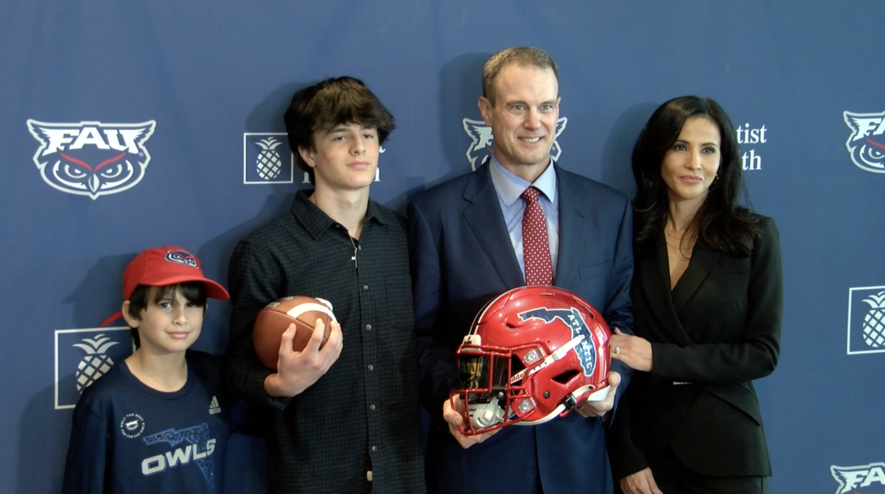 Tom Herman, wife and children pose after he's introduced as FAU Owls head coach, Dec. 1, 2022
