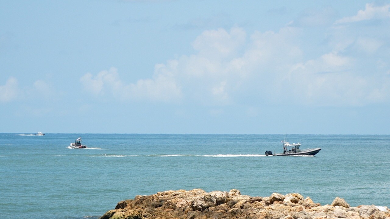 Search and rescue boats looking for the missing swimmer in the waters at Blind Pass on Captiva.