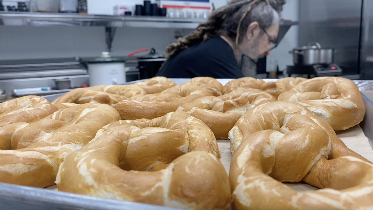 Chad brings out pretzels from the oven.