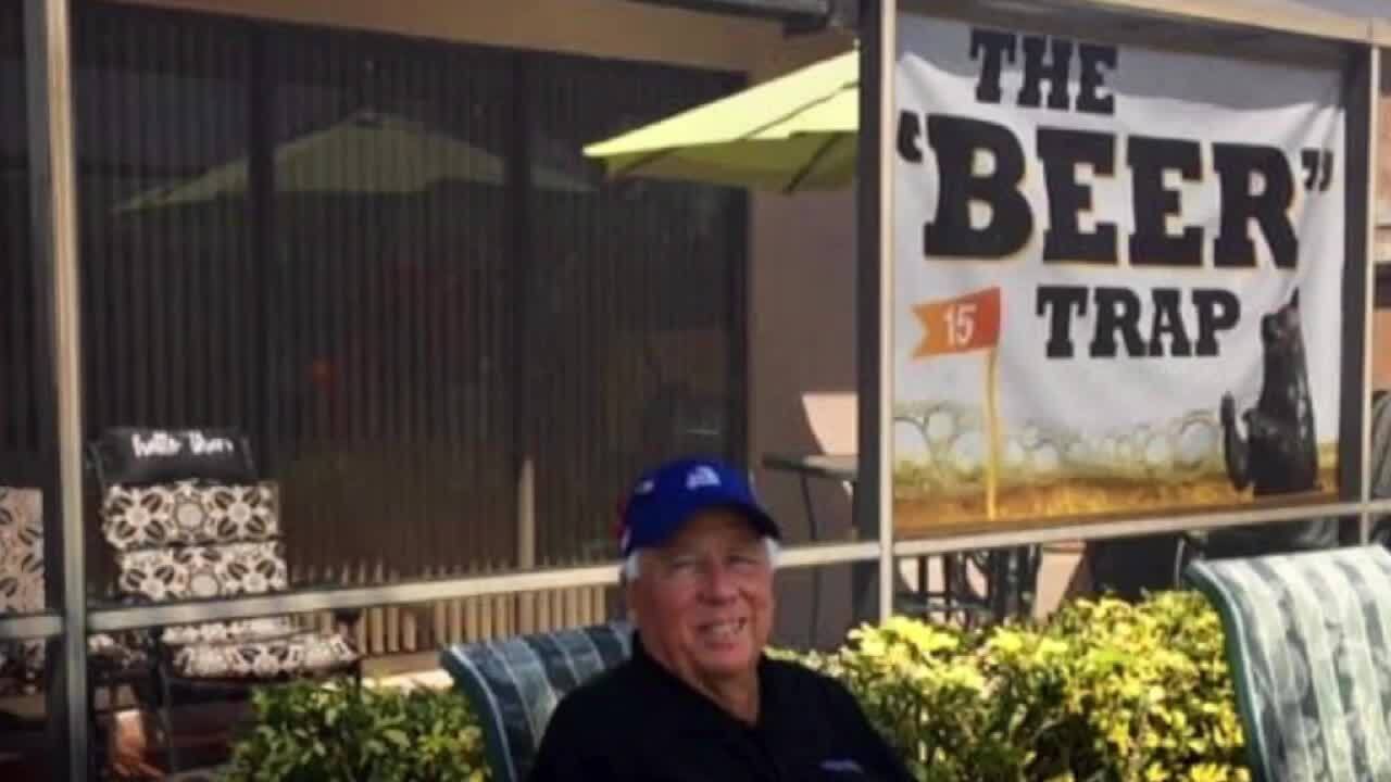 Larry Murphy sits behind the 'Beer' Trap sign