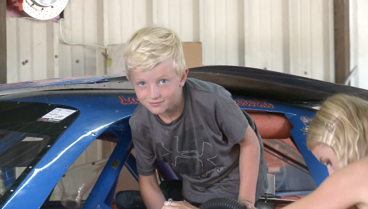 Renton Sokoloski climbs into the race car