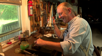 Chris Hagemann, in his shop, works on a speaking trumpet.