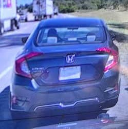 May be an image of car, rearview mirror, road and text.png