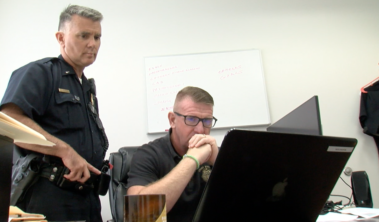 Norwood Police Lt. Ron Murphy and Chief William Kramer watch Facebook video of the brawl