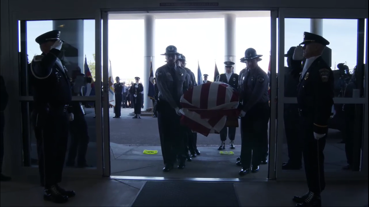 Officers carry in the casket of fallen Deputy Andrew Peery