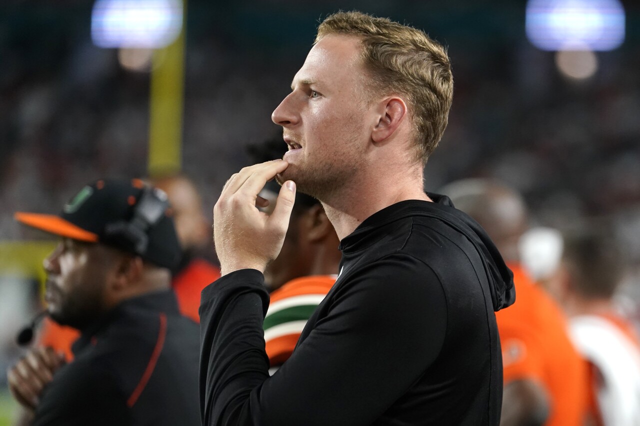 Miami Hurricanes QB Tyler Van Dyke watches game against Clemson Tigers from sideline, Oct. 21, 2023