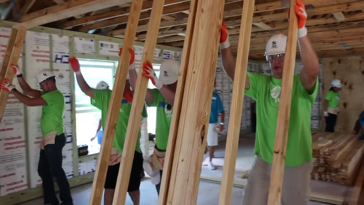 FPL workers help put up walls on new home for Diana Mores in West Palm Beach, Sept. 15, 2023