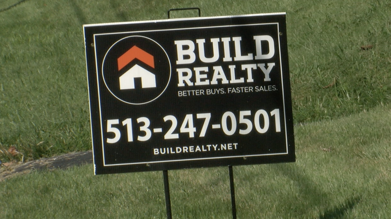 A Build Realty sign in front of a Madisonville home.