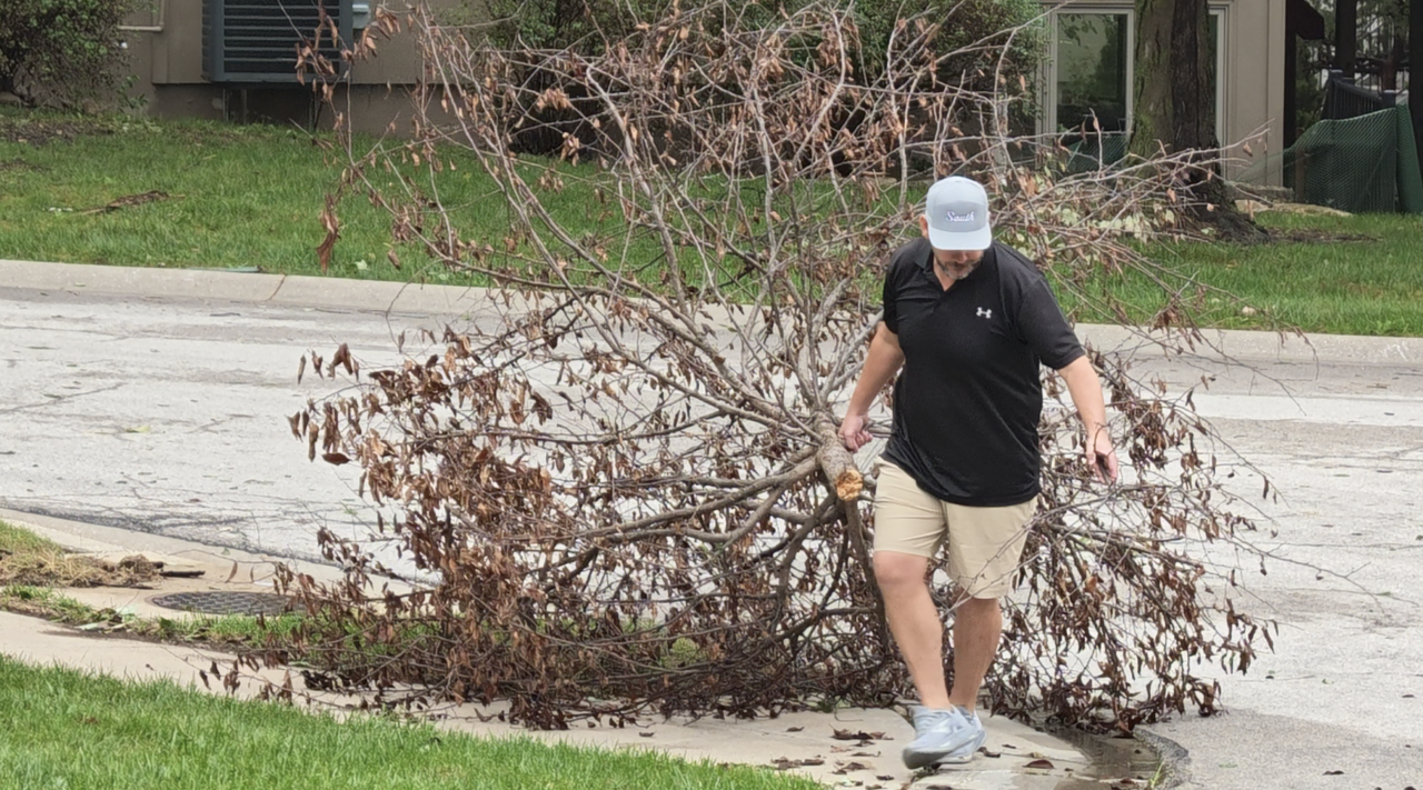 Resident picking up after storms