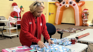 Volunteers help Milwaukee's Northcott get ready for a free Christmas dinner and gift giveaway