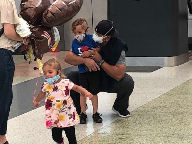 Paul Boykin hugs children