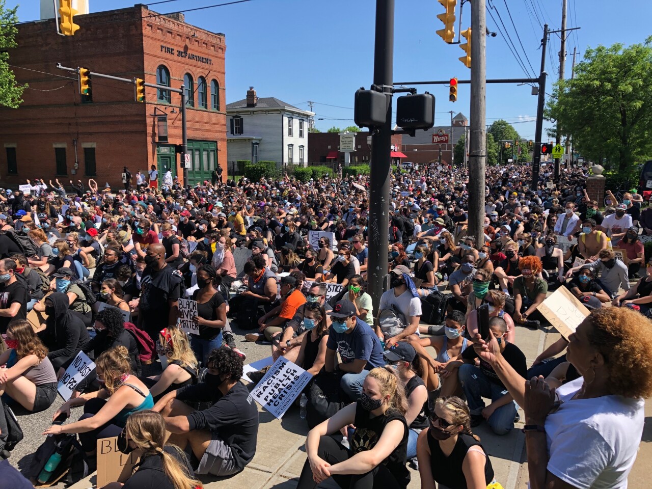 Peaceful protesters sit down on West 25th Street during a weekend demonstration on June 6.