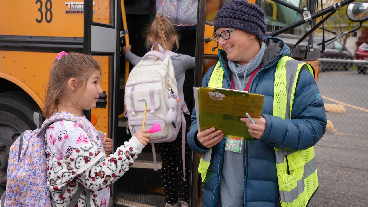 Little girl getting on bus 